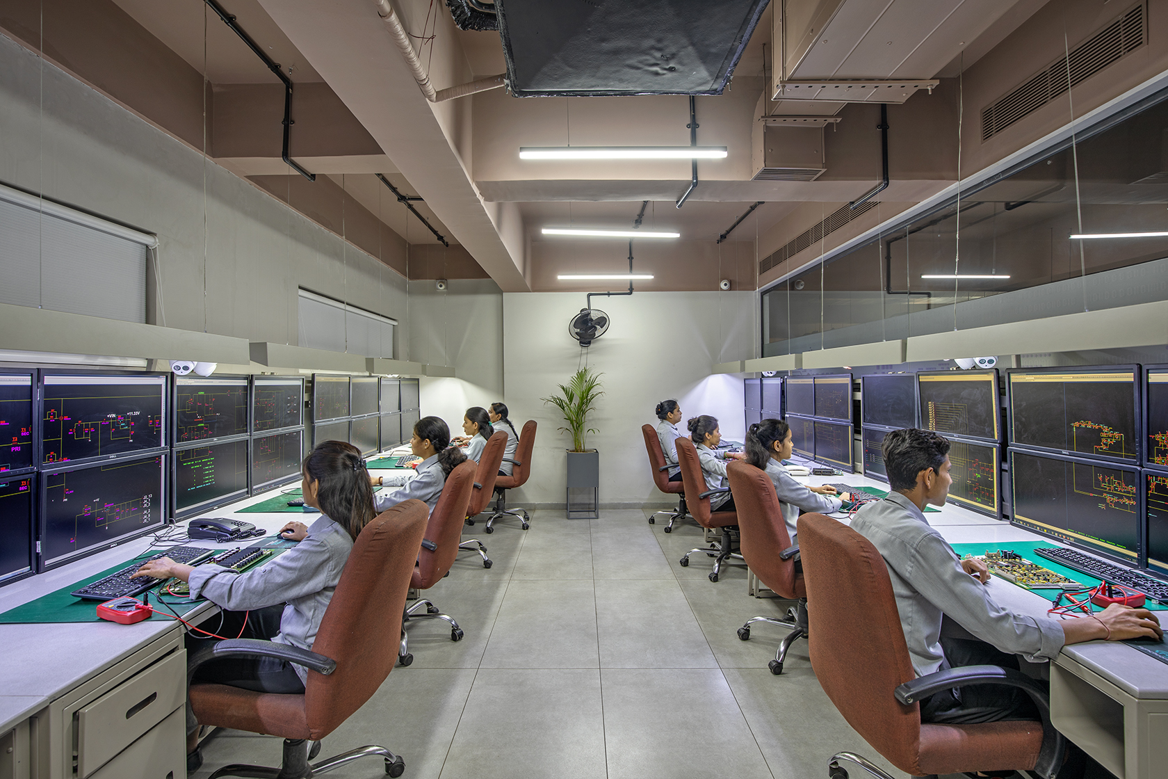 Synchronics Reverse Engineering Team — engineers working on PCB analysis with schematics on screen